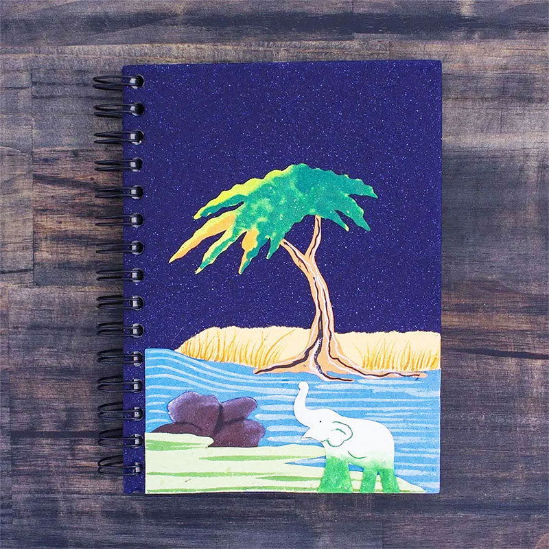 A journal notebook with an elephant and a tree